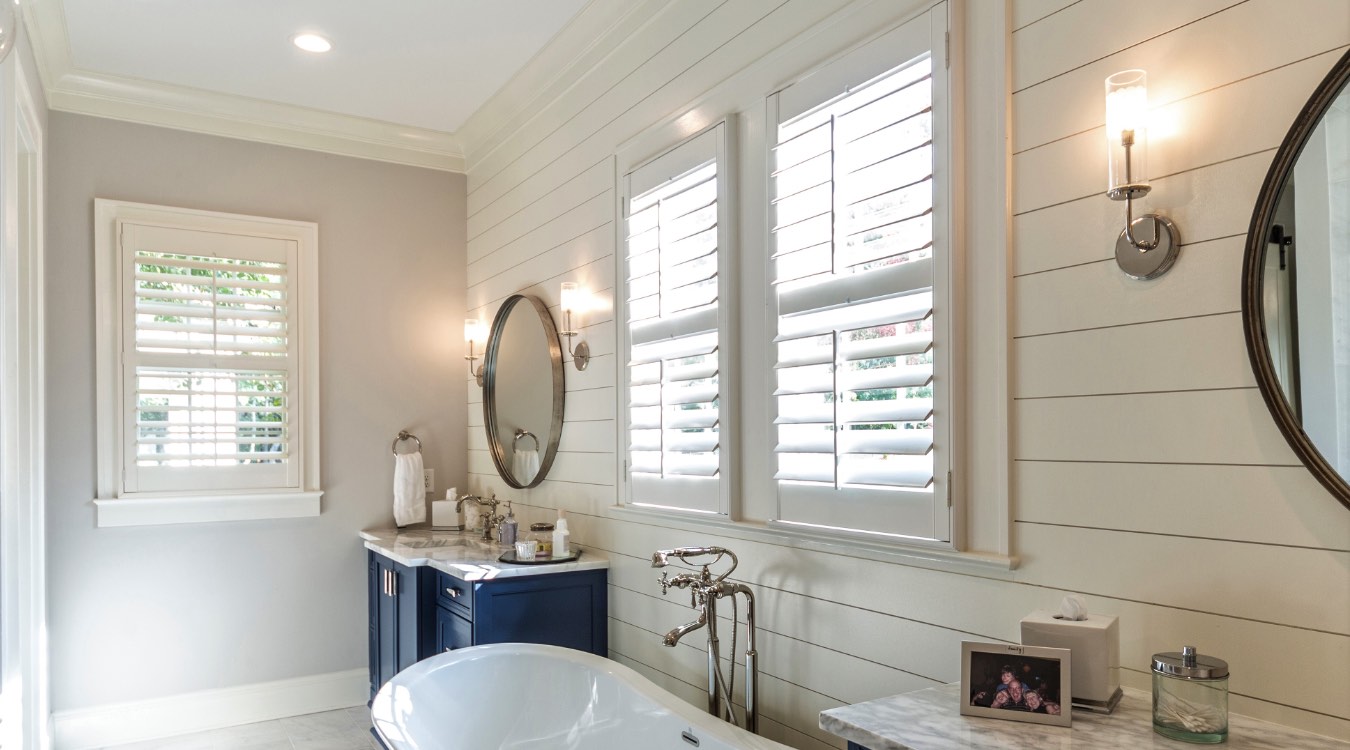 Tampa bathroom with white plantation shutters.