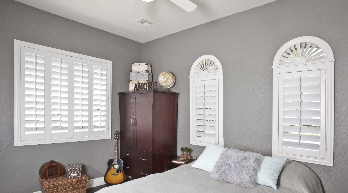 Arched interior shutters in bedroom
