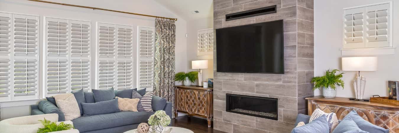 Plantation shutters in Greater Carrollwood living room with fireplace