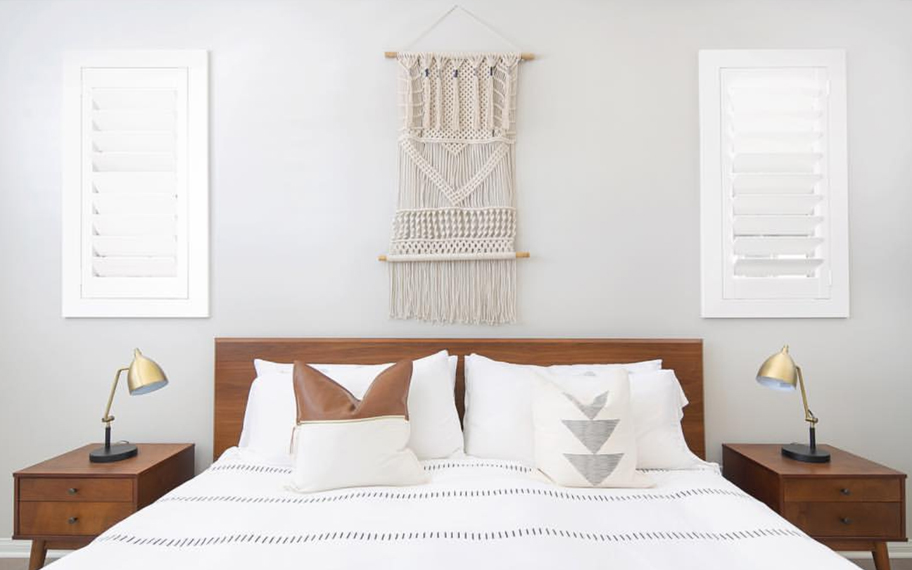 Custom-fitted louvered shutters provide excellent nighttime privacy in Tampa. Photo Credit: Audrey Crisp Louvered shutters in a bedroom.