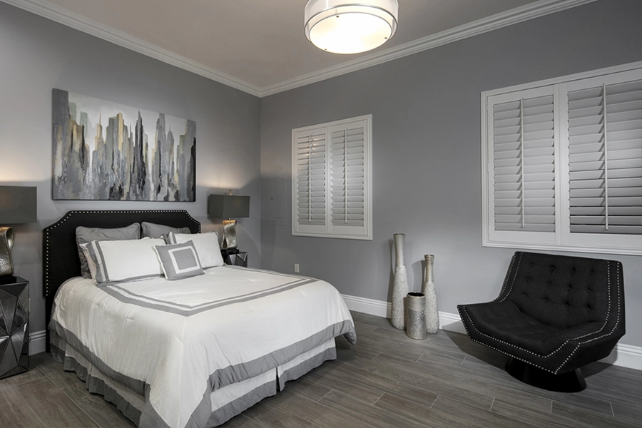 Close your custom Polywood shutters to beat the heat and keep your Tampa bedroom cool. White Polywood shutters on bedroom windows
