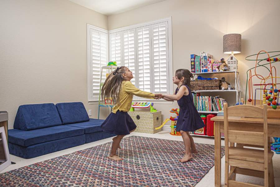 Choose Polywood shutters for durable, kid-friendly great room window treatments in Tampa. Polywood shutters on multiple windows in a sitting area