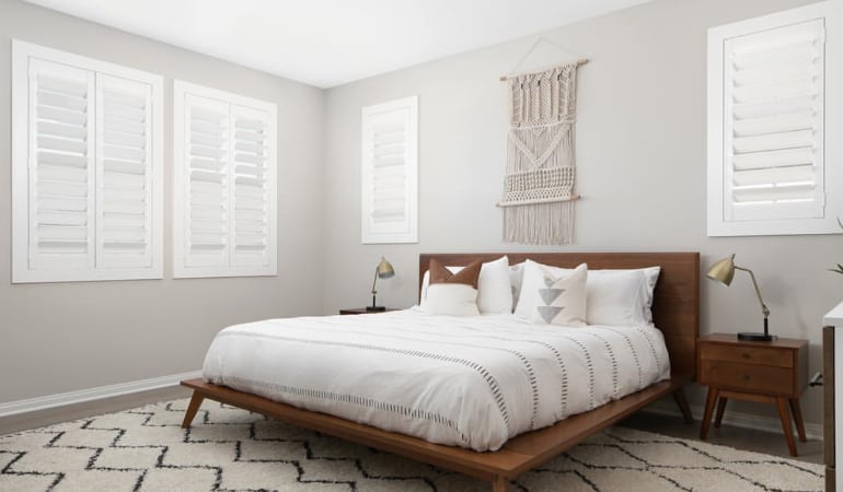 Open shutter louvers will help any Tampa room feel larger. Plantation shutters in a model home bedroom.