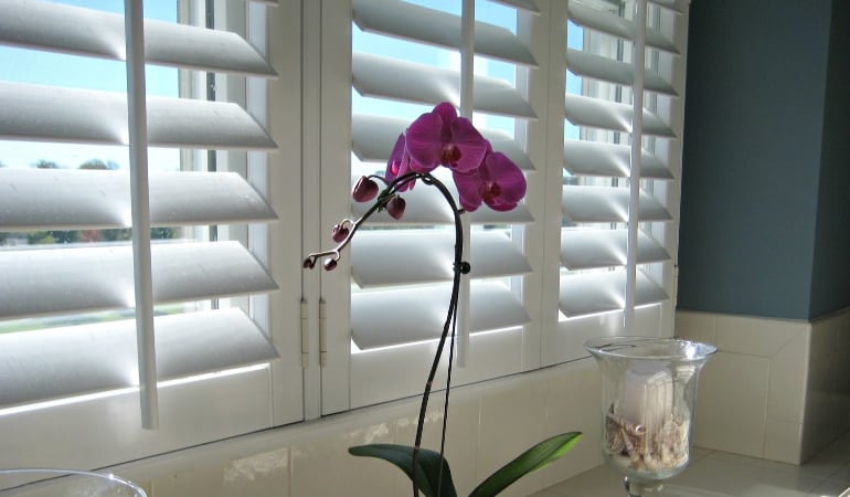 Polywood® shutters are the perfect choice for conserving energy in a room. Polywood® shutters in a window.