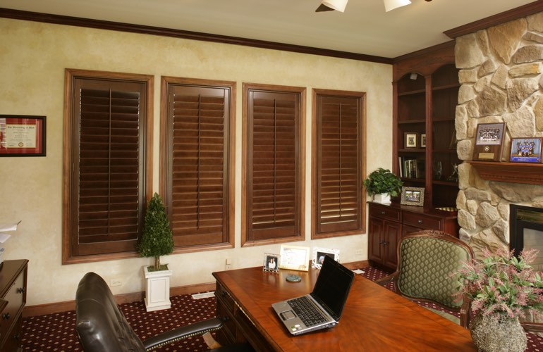 Wooden plantation shutters in a Tampa home office Wooden plantation shutters in a Tampa home office