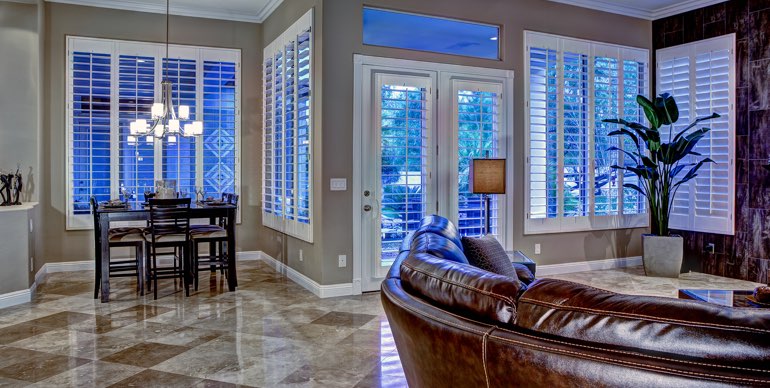 Tampa great room with classic shutters and leather furniture.
