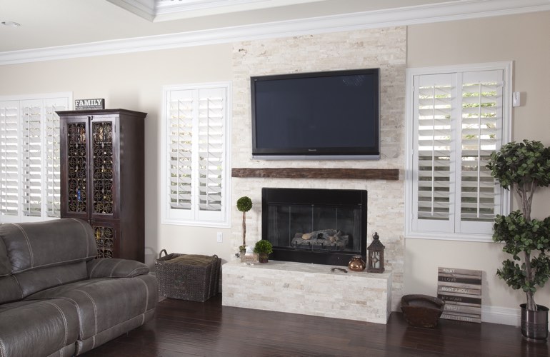 White plantation shutters in a Tampa living room with plank hardwood floors. White plantation shutters in a Tampa living room with plank hardwood floors.