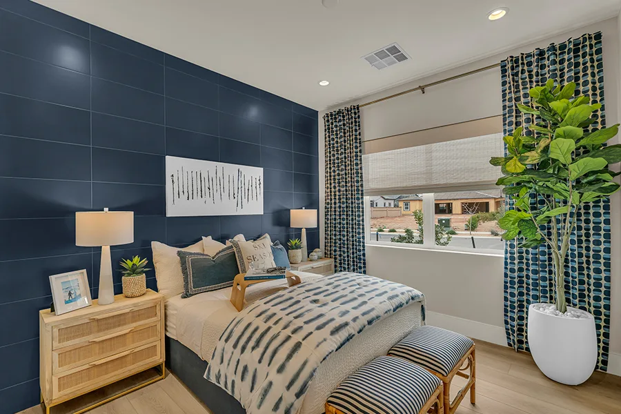 White woven shades halfway down over a bedroom window and paired with blue drapes Millicent Parsons