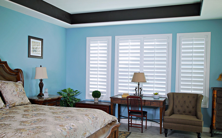 Polywood shutters provide insulation for the perfect temperature all year long in Tampa. Polywood shutters in a bedroom.