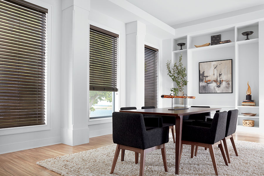 With so many stylish window treatments to choose from, it's easy to find something that complements your dining room decor. Dark brown window blinds on three dining room windows