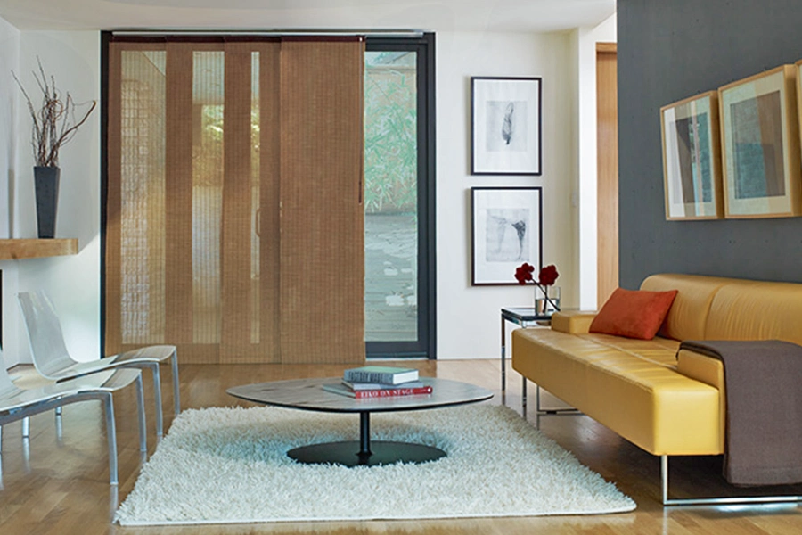 Panel track fabric window treatment covering a sliding glass door in a stylish living room