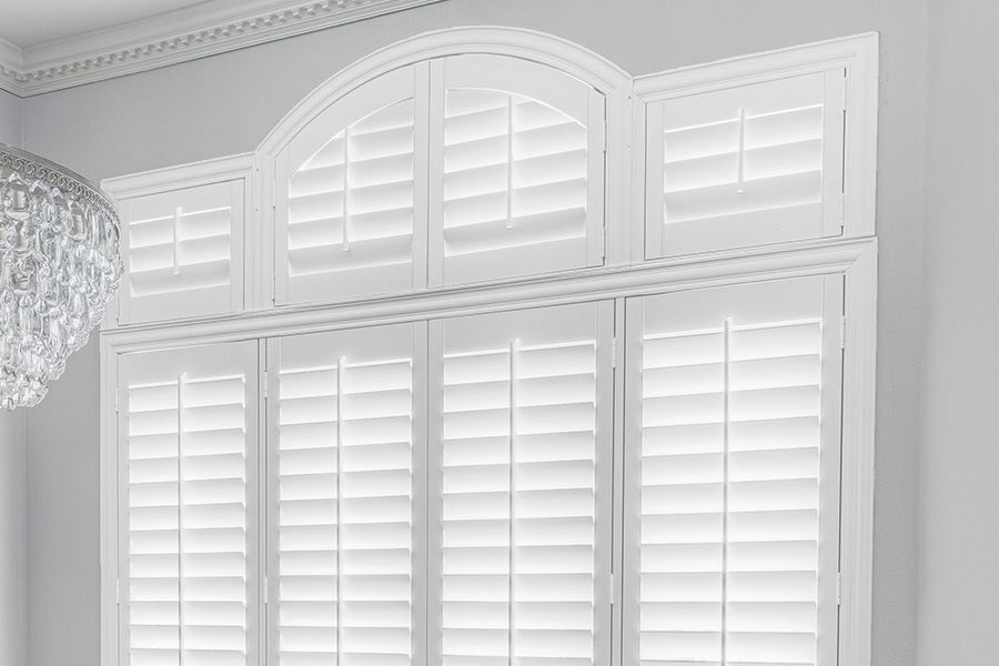 Customize your Palladian windows with white Polywood shutters in Tampa. White Polywood Palladian windows in a dining room.