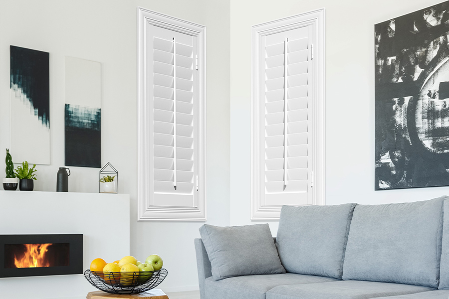 White Polywood shutters add character and class in Tampa. White polywood shutters in a corner of a modern living room.