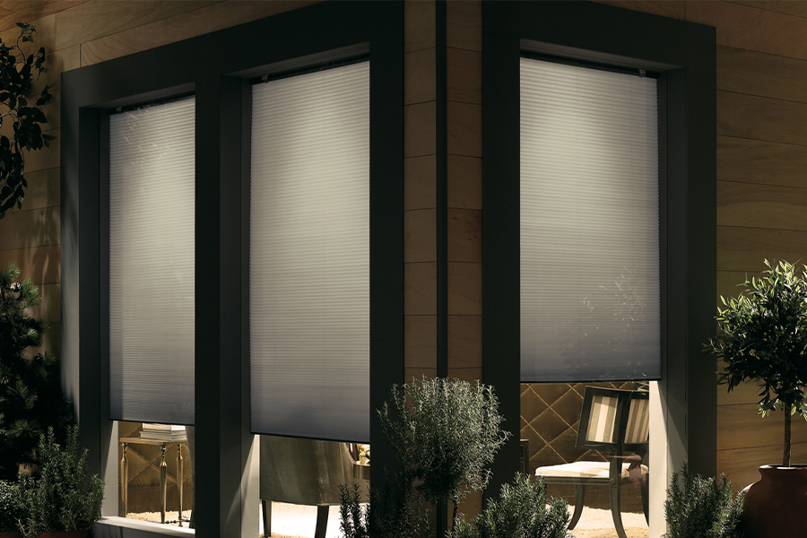 Cellular shades are modern and stylish window treatments for your home in Tampa. Dark gray cellular shades displayed from the exterior of a home.